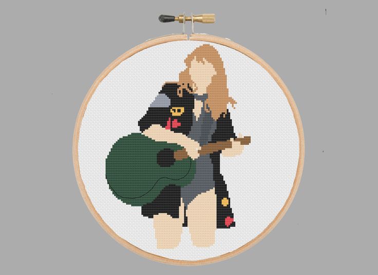 a cross stitch pattern of a woman holding a guitar and wearing a black outfit,