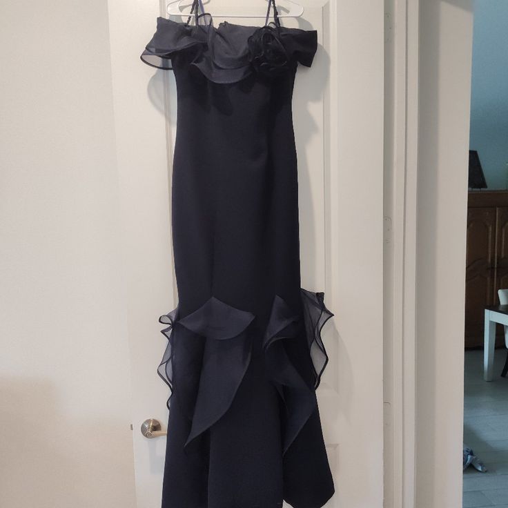 Beautiful Navy Blue Gown. Size 18, Really Fits Size 14. Never Worn, And Not Altered. Model Shows Black, However I Purchased Navy Blue. Purchased At Infinity Of Boca Raton. Formal Long Evening Dress With Ruffles, Formal Long Gown With Ruffles, Blue Evening Dress With Ruffles, Blue Ruffled Evening Dress For Formal Events, Blue Ruffled Evening Dress For Formal Occasions, Formal Floor-length Evening Dress With Ruffles, Blue Ruffled Gown For Cocktail, Fitted Ruffles Mother Of The Bride Evening Dress, Blue Ruffled Cocktail Gown