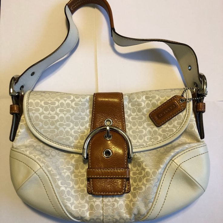 I Coveted This Bag For So Long, And When I Finally Bought It I Never Used It Out Of Fear Of It Getting Dirty! So Now This Bag Is Considered Vintage And Is In Mint Condition! There Are No Stains And No Signs Of Wear On This Bag! It Has The Mini Signature C Design In White On White, With White Leather On The Bottom And Dark Brown Leather Accents And Handle. This Bag Is Beyond Gorgeous! It Also Has An Inside Flap Pocket, Shown In Picture 4 As Well As The Regular Inside Complete With A Zipper Pouch. Classic White Shoulder Bag With Leather Handles, White Bags With Leather Handles For Formal Occasions, White Formal Bags With Leather Handles, Formal White Bags With Leather Handles, White Shoulder Bag With Silver-tone Hardware And Double Handle, Cream Shoulder Bag With Branded Hardware For Formal Occasions, Formal Cream Shoulder Bag With Branded Hardware, White Tote Shoulder Bag With Silver-tone Hardware, White Coach Evening Bag