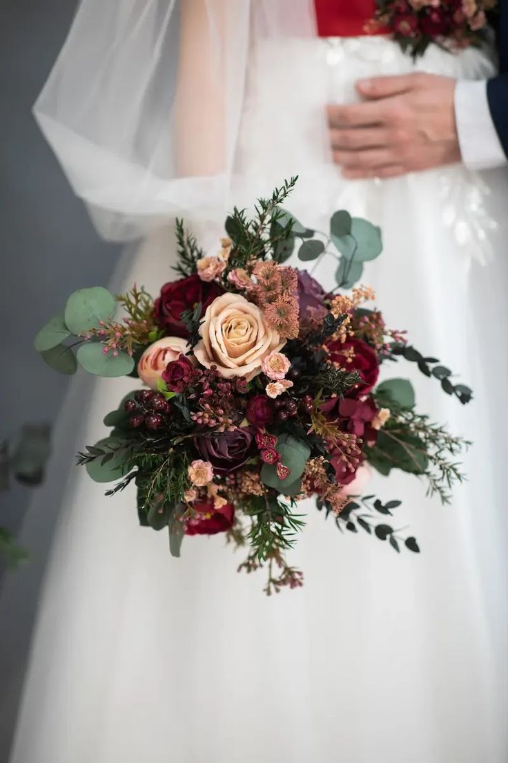 a bride and groom holding their bouquet