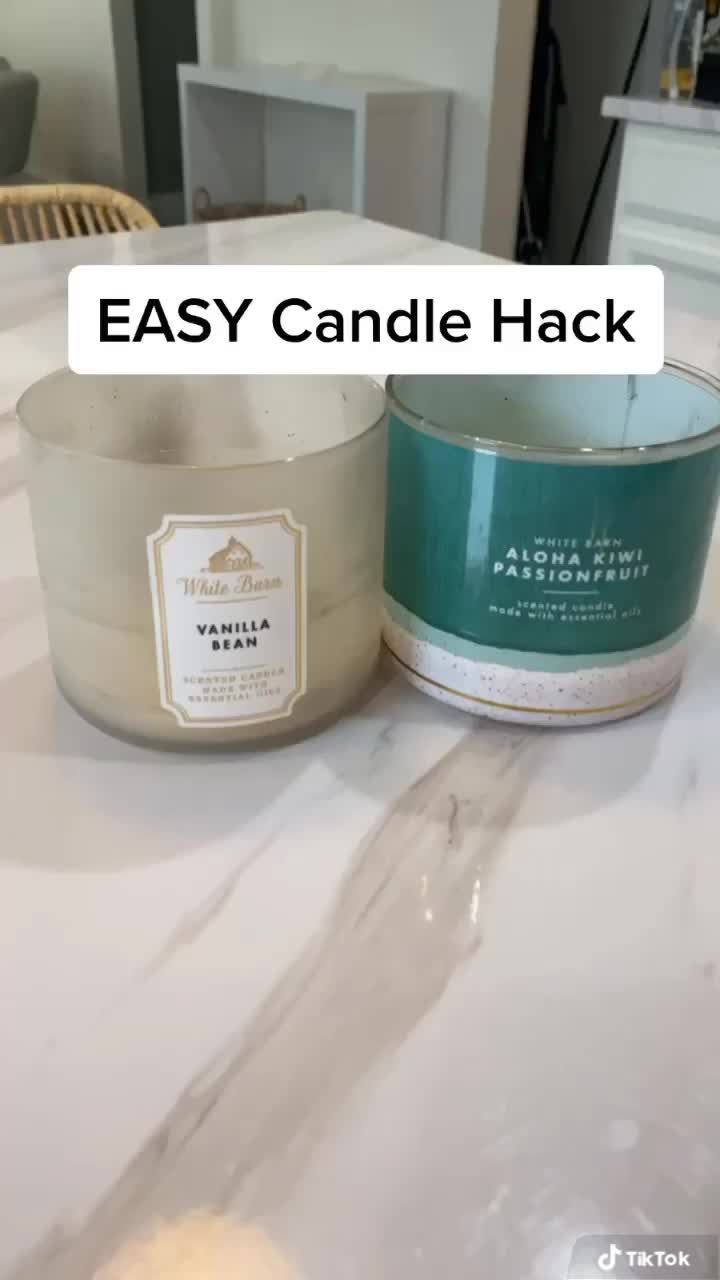 two candles sitting next to each other on a table with the words easy candle hack