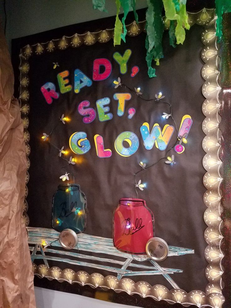 a bulletin board that says ready, set, glow with lights and decorations on it