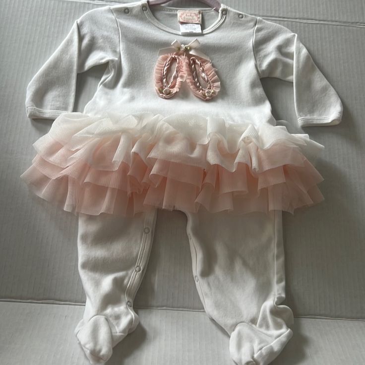 Beautiful Soft One Piece Baby Biscotti Outfit With Ballet Slippers On The Front And 4 Layers Of Tulle Ruffles To Make A Beautiful Tutu Attached To Outfit . Washed But Never Worn . Box 1c White Ruffled Onesie For Playtime, White Ruffled Onesie For Playwear, White Onesie For Baptism In Spring, Baby Ballet, Tulle Ruffles, Ballet Clothes, Ballet Slippers, Coming Home Outfit, Coming Home