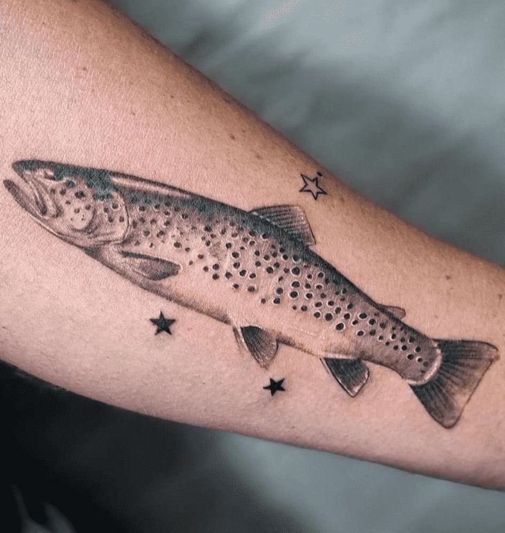 a fish tattoo on the arm with stars