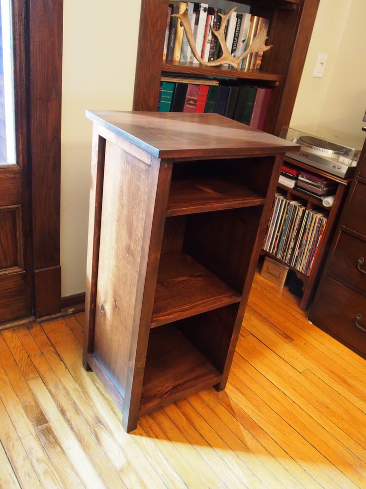 a book shelf sitting on top of a hard wood floor