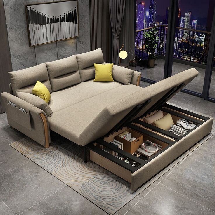 a couch that is sitting in the middle of a living room with its pull out bed