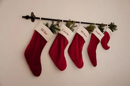 christmas stockings hanging on the wall with name written on them