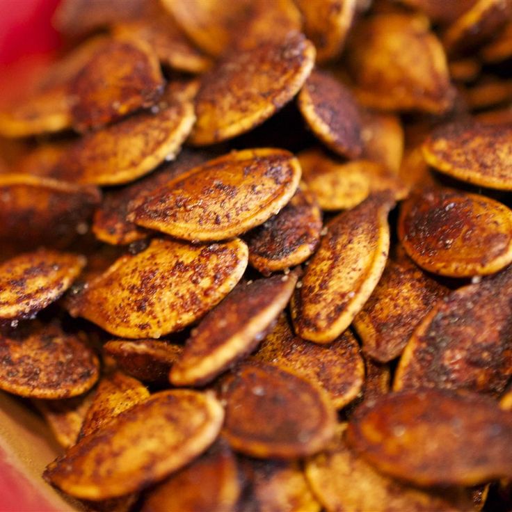 a pile of pumpkin seeds sitting on top of a table