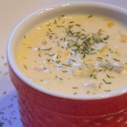 a red bucket filled with soup and garnished with herbs