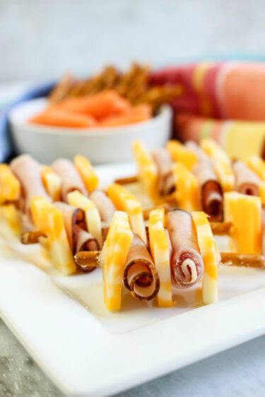 several appetizers are arranged on a white platter and ready to be eaten