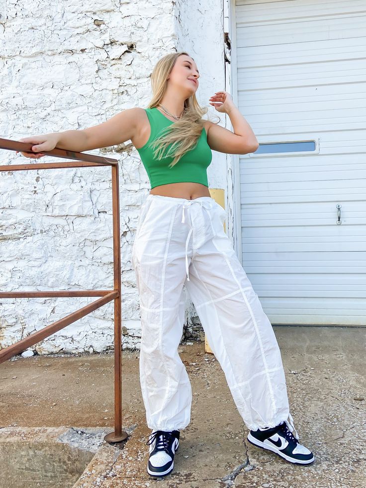 White parachute cargo pants. They have a drawstring waist and are loose fitting. SALE ITEMS ARE FINAL SALE Return Policy ALL SALE ITEMS ARE FINAL SALE! Feel free to email us at info@shopluxxeapparel.com or DM us with any questions regarding fit, styling, or our return policy in general. To read more into our return policy please click here. White Parachute Pants Outfit, White Parachute Pants, Parachute Pants Outfit, Flo Milli, Parachute Cargo Pants, Parachute Cargo, Cargo Trousers, Spring Outfits Casual, Spring Summer Outfits