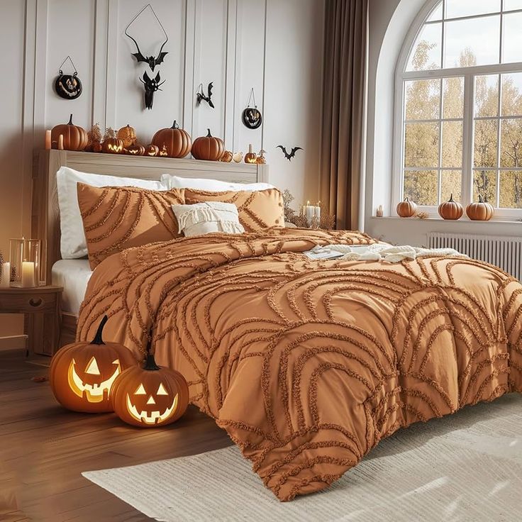 a bed with two pumpkins on the floor in front of it and a window