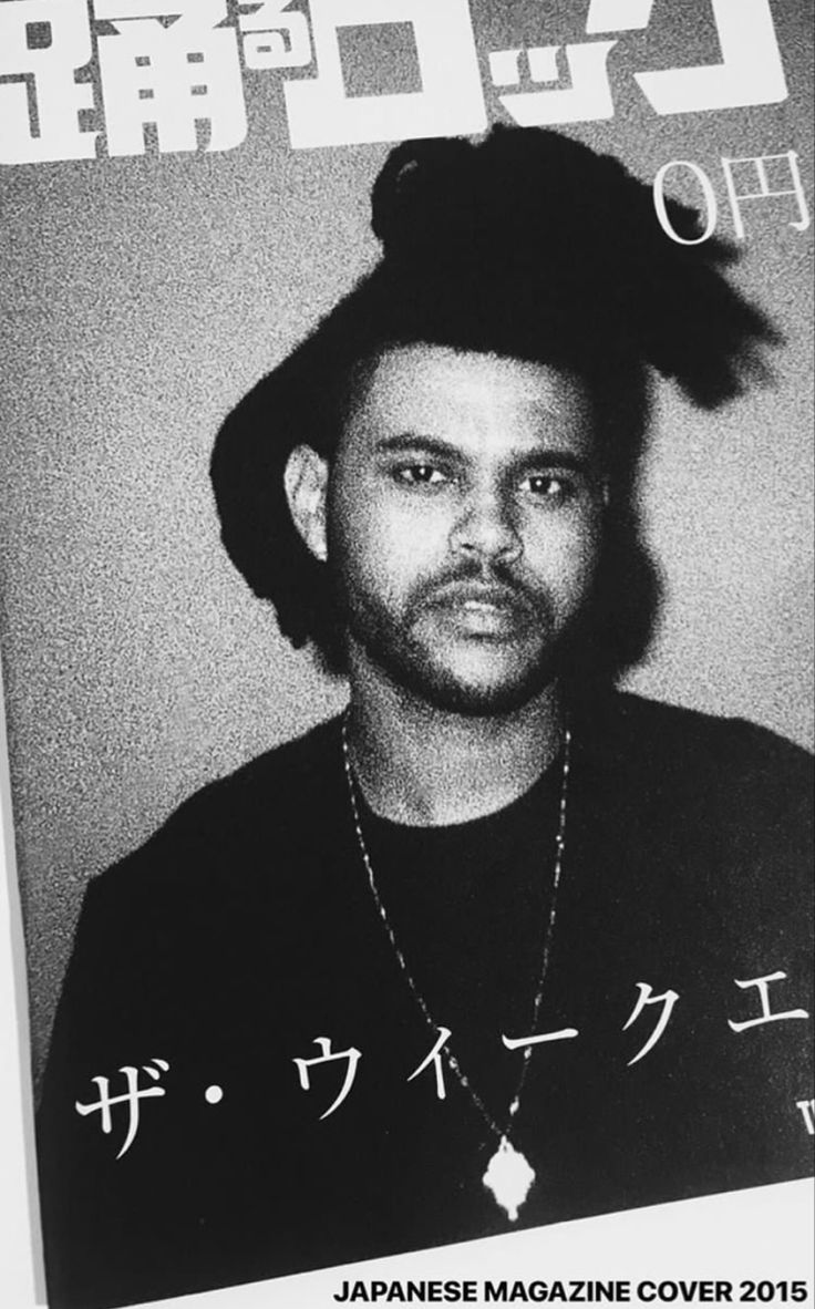 a black and white photo of a man wearing a hat with japanese writing on it