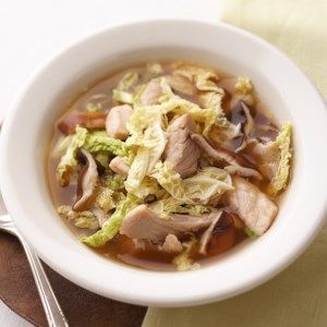 a white bowl filled with soup on top of a table