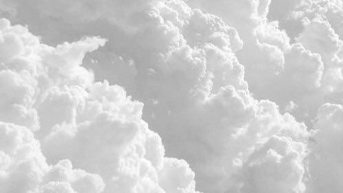 an airplane is flying through the clouds in this black and white photo by photographer person