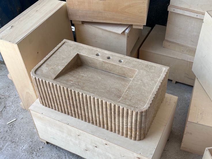 several wooden boxes stacked on top of each other in a room filled with unfinished furniture