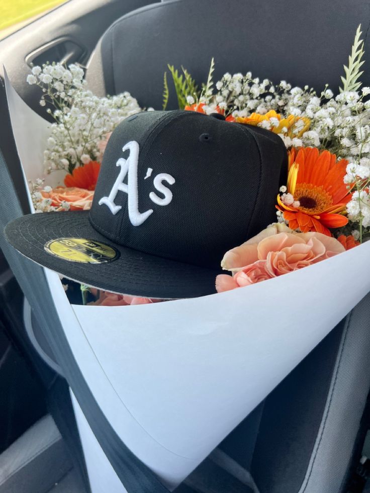 a baseball cap with flowers in the back seat of a car