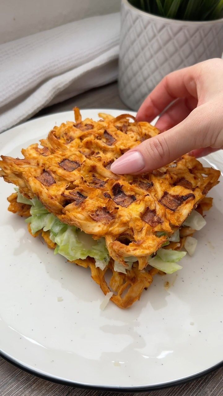 a person is reaching for some food on a plate