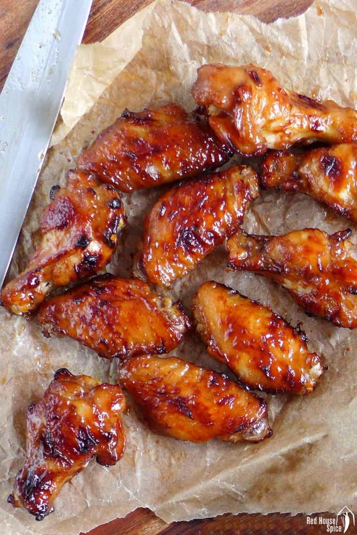 chicken wings on wax paper next to a knife