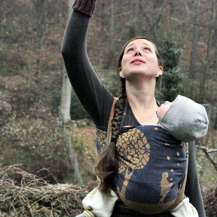 a woman holding an umbrella while standing in the rain with her hands up to the sky