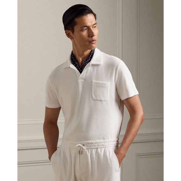 In a plush cotton blend this Polo shirt features a genuine mother-of-pearl button and “Ralph Lauren” script embroidery. Elegant White Polo Collar Tops, White Tops With Pockets And Collared Neckline, Casual Cream Johnny Collar Top, Casual Cream Top With Johnny Collar, Classic White Collared Top, Luxury Tops With Button Closure For Daywear, White Johnny Collar Tops With Pockets, Luxury Collared Shirt With Relaxed Fit, Classic Cream Top With Camp Collar