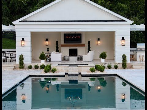 an outdoor living area with pool and patio furniture