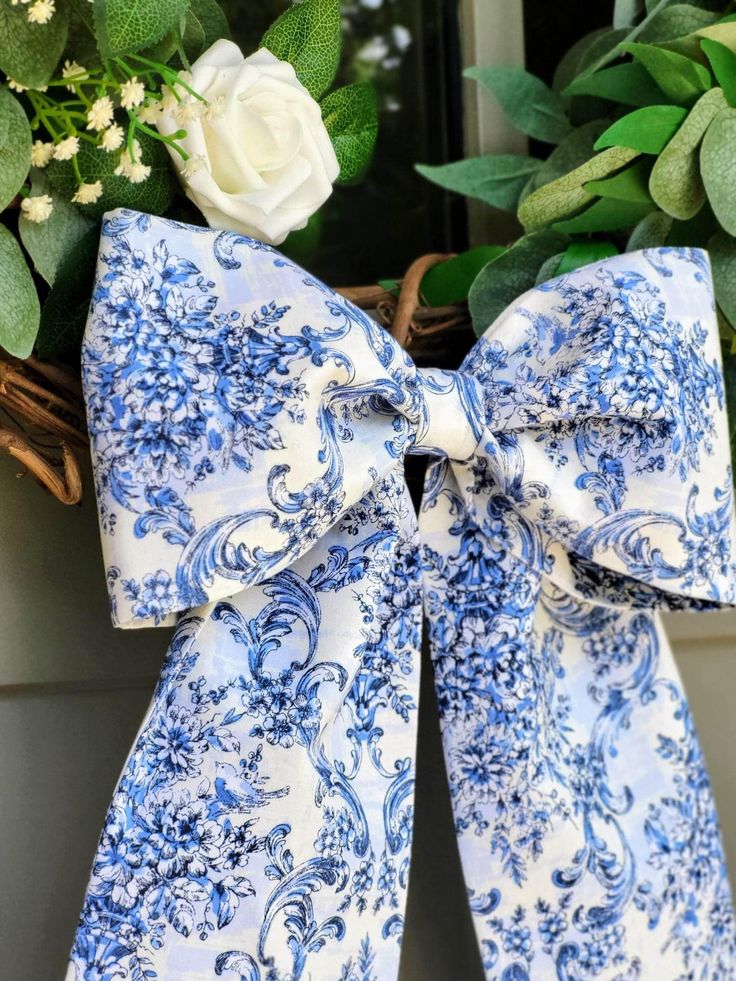 a blue and white bow on a wreath