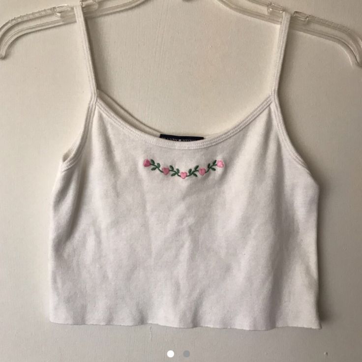 a white crop top with pink flowers on it