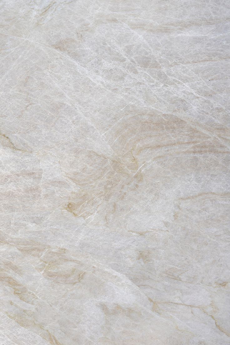 a white marble textured surface with light brown veining on the top and bottom