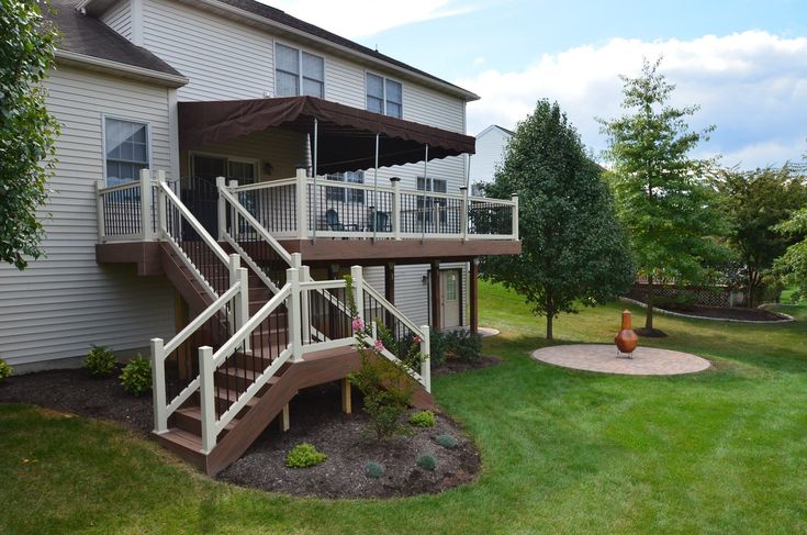 an apartment building with stairs leading up to the second floor