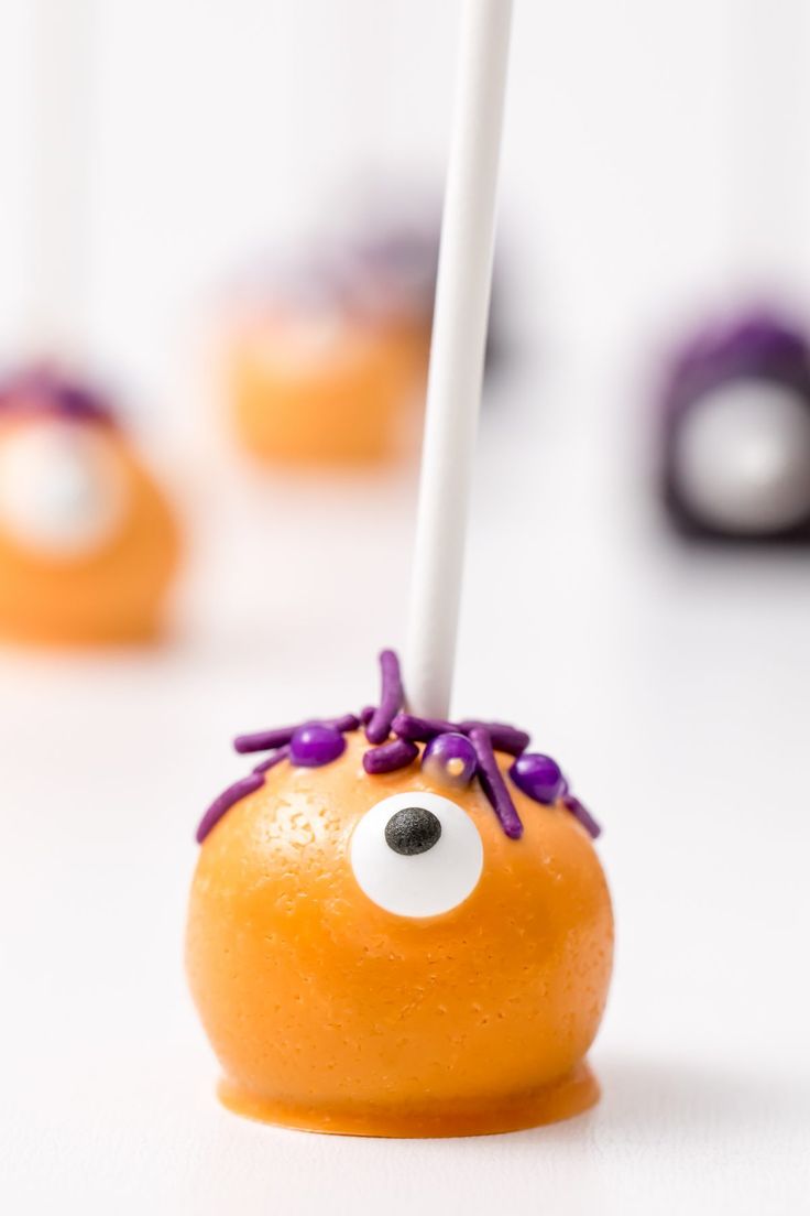 an orange with purple sprinkles and eyes on it