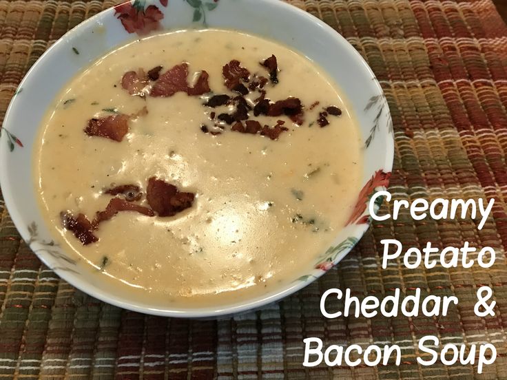 creamy potato cheddar and bacon soup in a white bowl on a tablecloth