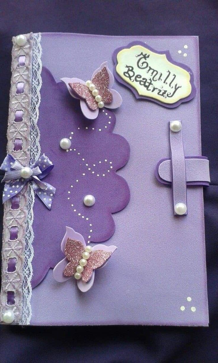 a purple book with pearls and butterflies on it