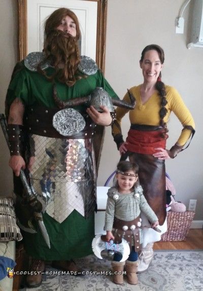 two people and a child are dressed up in costumes