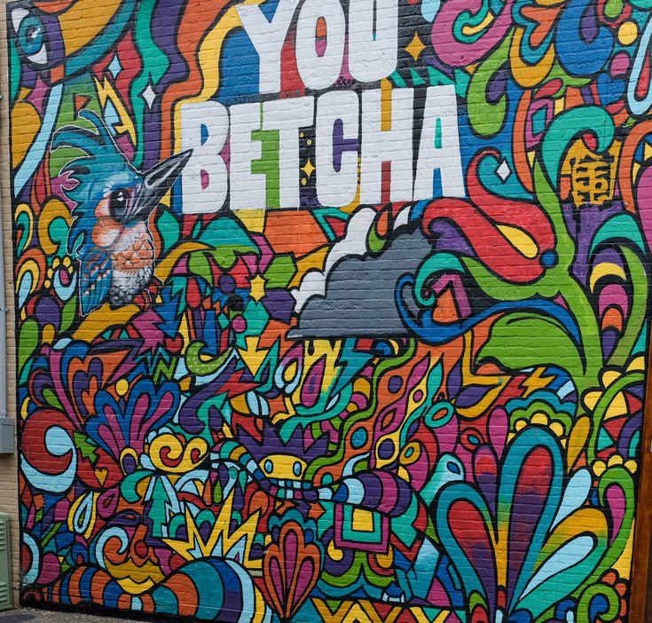 a mural painted on the side of a building that says, you betcha