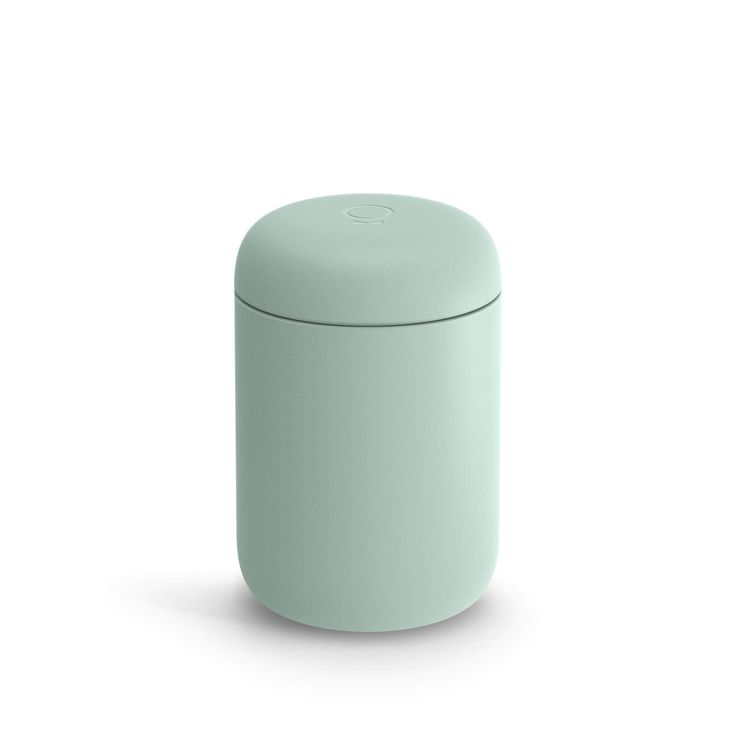 a light green round container with a lid