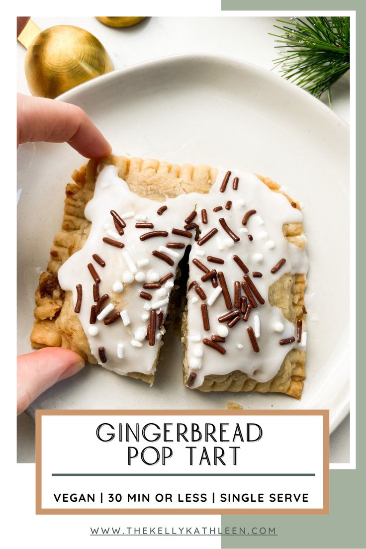 a person holding a piece of bread with white icing and sprinkles