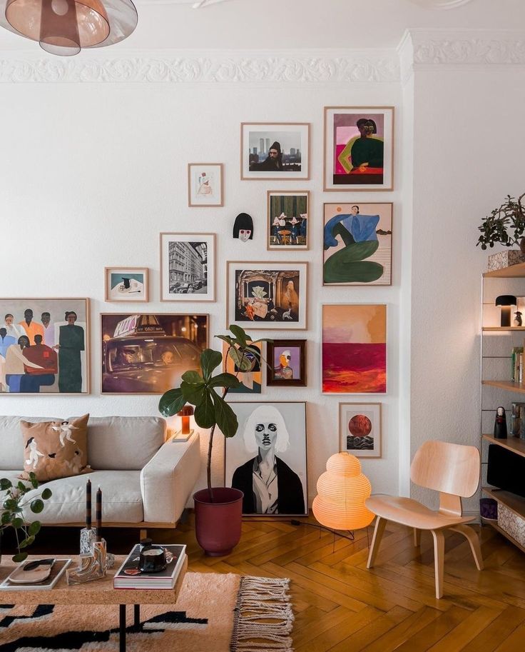 a living room filled with furniture and lots of pictures on the wall above it's coffee table