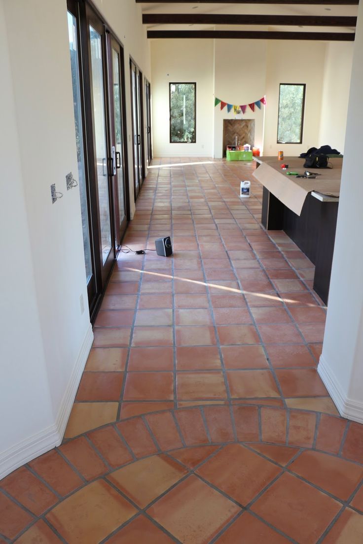 an empty hallway leading to the kitchen and living room in a house that is being renovated