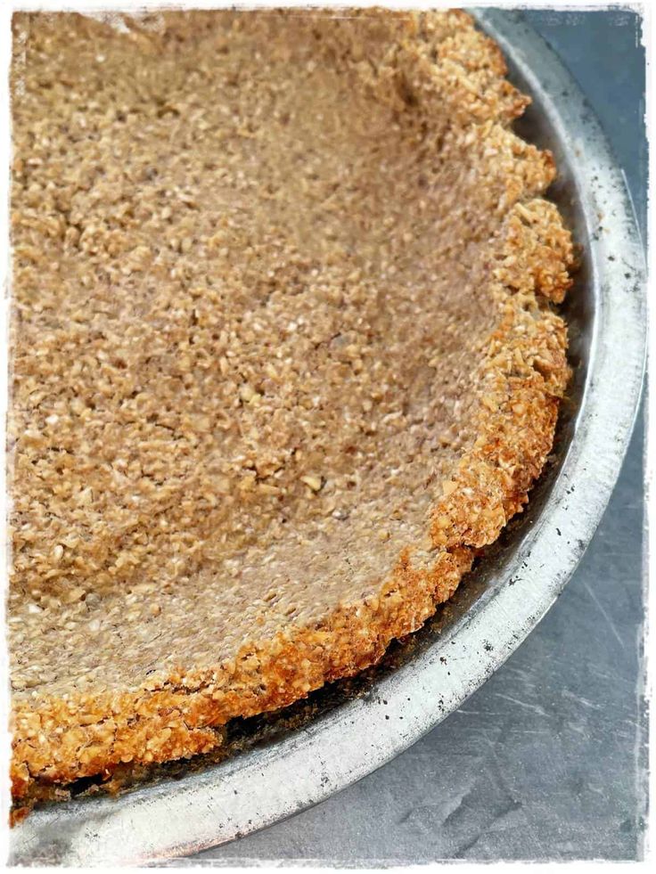 a pie crust in a metal pan on a table