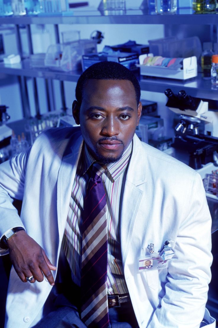 a man wearing a suit and tie in a lab