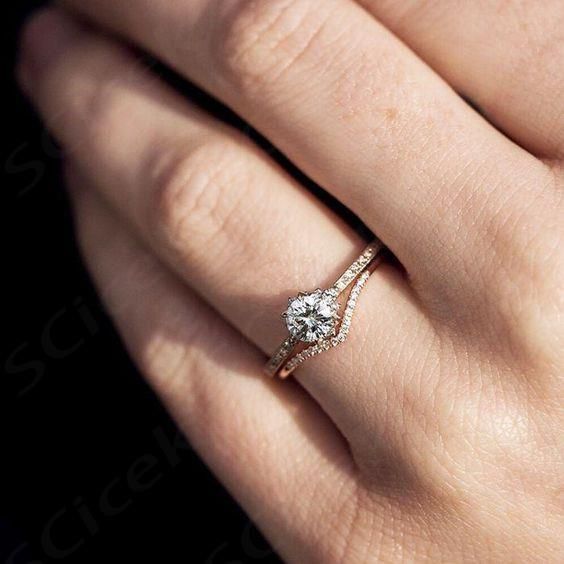 a woman's hand with a diamond ring on it