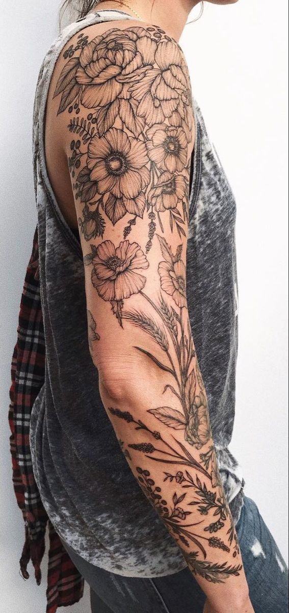 a man with a flower tattoo on his arm