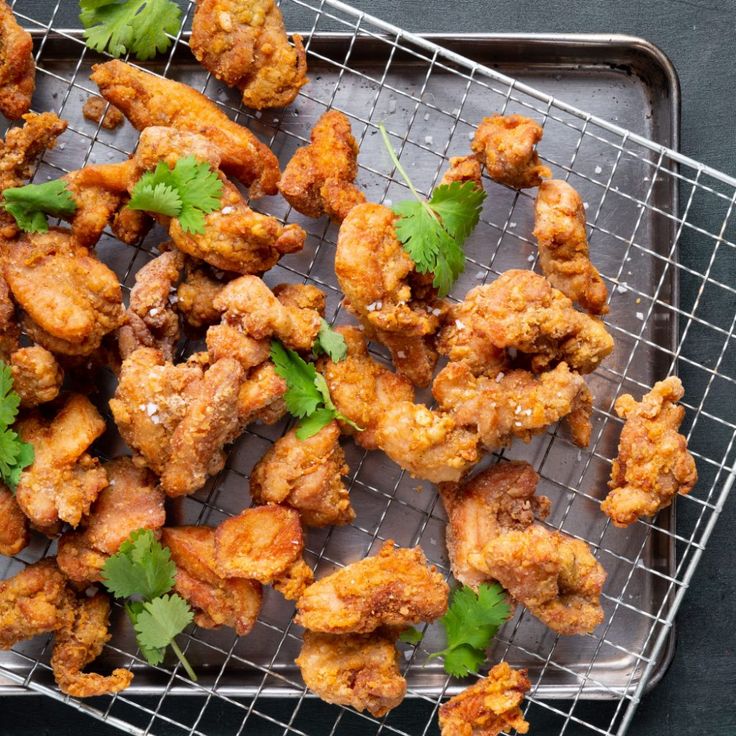 chicken wings with cilantro and parsley on a cooling rack, ready to be cooked