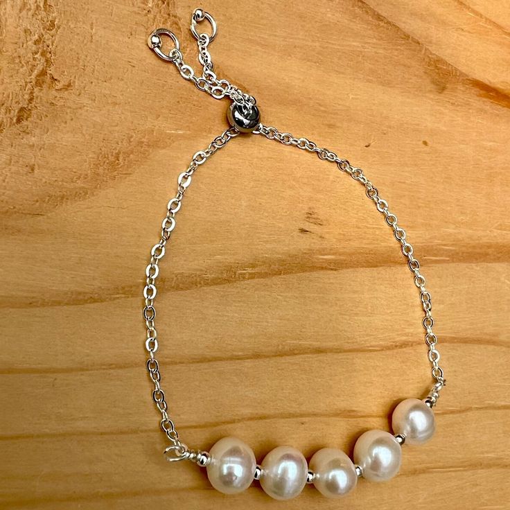 This adjustable Pearl bracelet is made with tarnish resistant silver plated wire and chain. The clasp slides to adjust up to 9 inches. The pearls are freshwater pearls and are a June birthstone. Fast free domestic shipping from Portland, Oregon. I try to ship the same or next day of your order. Your item will arrive in a gift box with bow and my shop name suitable for gift giving. I am happy to send it directly to your gift recipient and include a card with your special message. Just mention it in your buyers notes when you order. You can follow me on Instagram @banbajewelry Pinterest @banba3 Adjustable Sterling Silver Pearl Charm Bracelet, Adjustable Pearl Bracelet With Extender, Silver Pearl Bracelets With Adjustable Chain, Silver Pearl Bracelet With Adjustable Chain, White Adjustable Pearl Bracelet, Adjustable Pearl Bracelet For Anniversary, Adjustable Pearl Chain Bracelet For Anniversary, Adjustable Sterling Silver Pearl Drop Bracelet, Adjustable Silver Bracelet With Pearl Charm