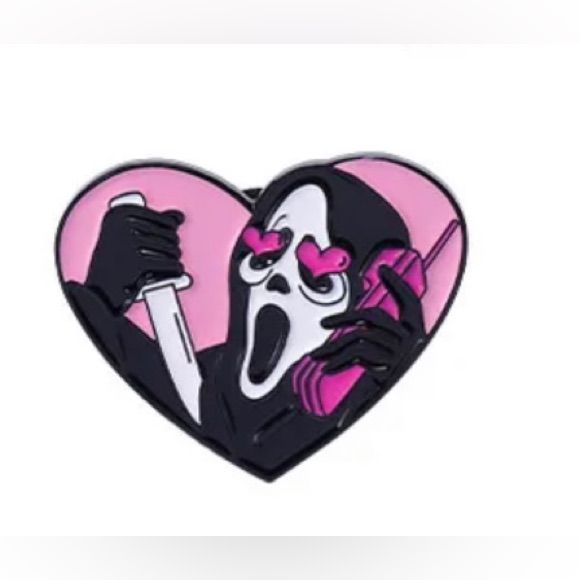 a pink and black heart shaped pin with a cartoon character holding a knife in it