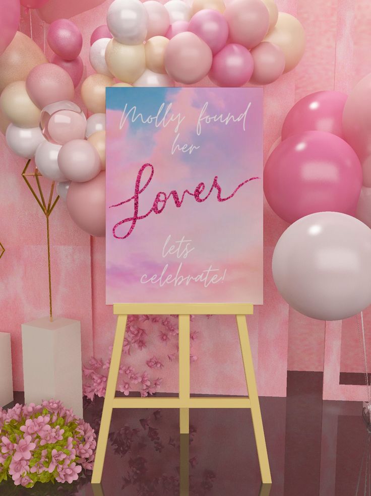 a welcome sign and balloons in front of a pink backdrop for a birthday party or baby shower