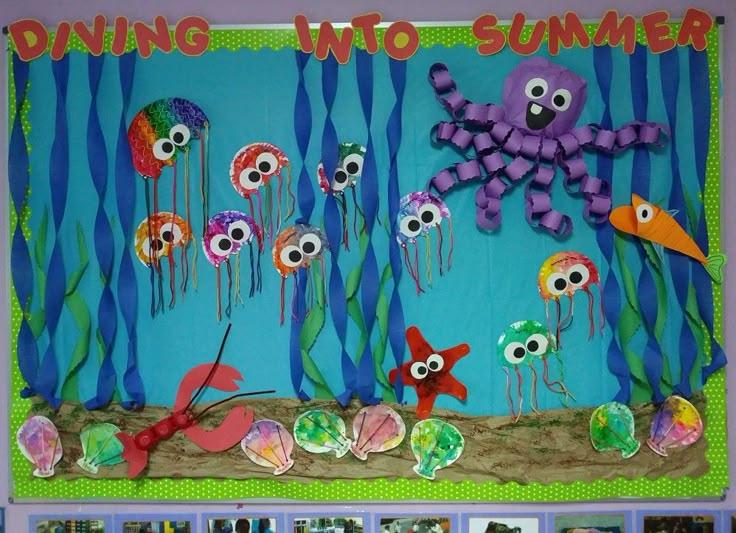 a bulletin board with an octopus, fish and jellyfish under the sea on it