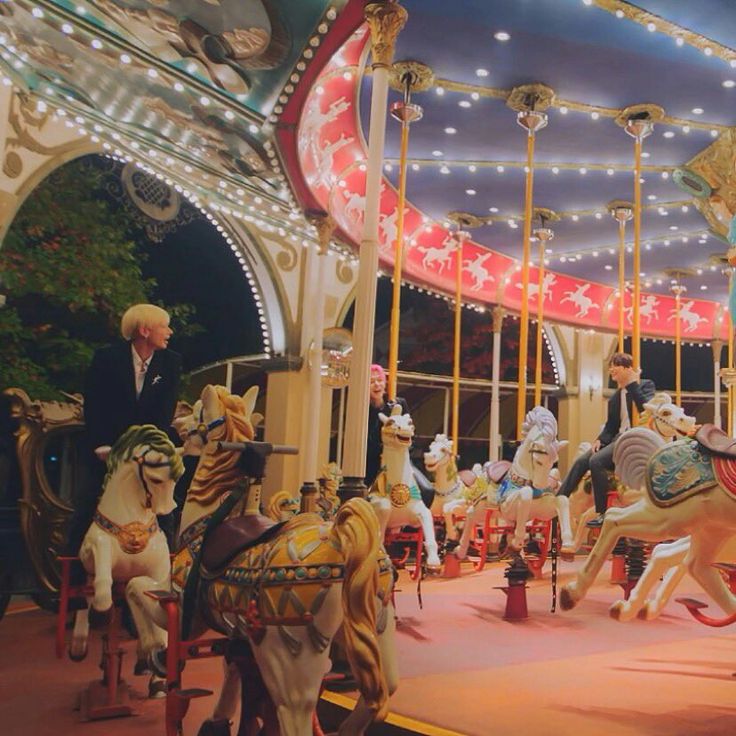 the carousel is decorated with colorful lights and figurines