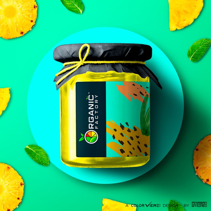 a jar of pineapple jam sitting on top of a blue plate with leaves around it